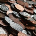 Close-up of various international coins in a pile, showcasing different currencies and designs.